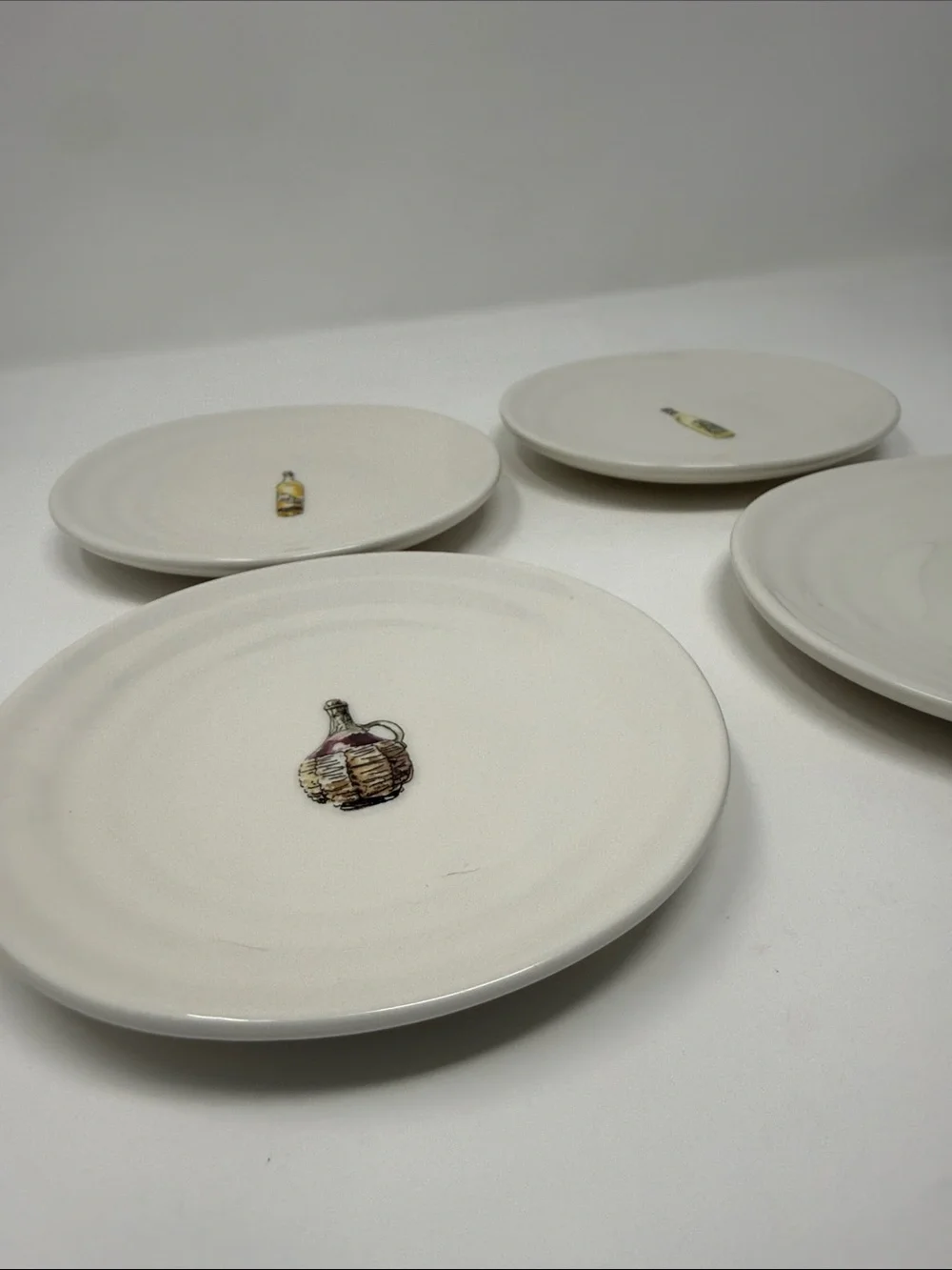 Williams Sonoma Cream Ceramic Dinner Plates with Wine Bottle Motifs - Set of 4